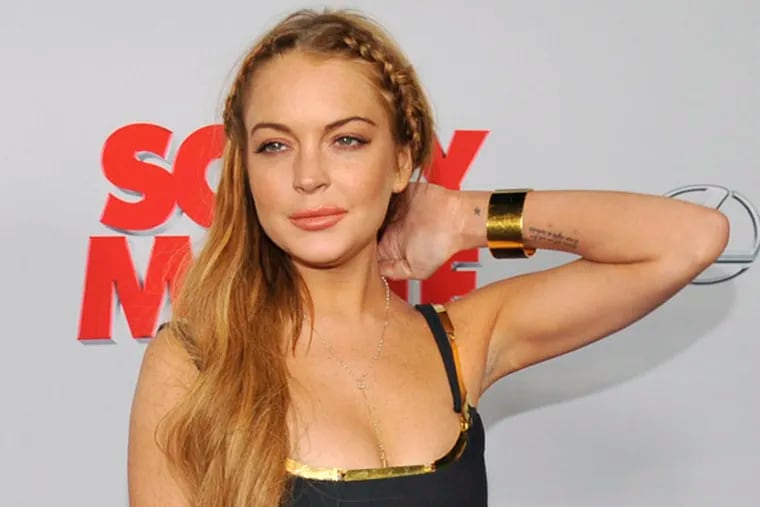 Lindsay Lohan, a cast member in "Scary Movie V," poses at the Los Angeles premiere of the film at the Cinerama Dome on Thursday, April 11, 2013 in Los Angeles. (Photo by Chris Pizzello/Invision/AP)