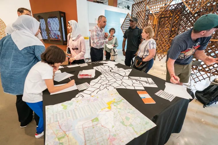 Yaroub Al Obaidi, center, co-founder of The Friends, Peace, and Sanctuary Journal, at the organization's launch of a project called Mapping Philadelphia in Arabic as Storytelling, at the Museum for Art in Wood, in Philadelphia, Friday, July 14, 2023.