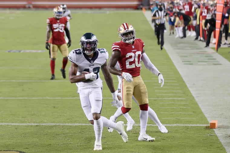Eagles wide receiver Travis Fulgham celebrates after edging past San Francisco 49ers cornerback Dontae Johnson to score a touchdown in the fourth quarter of Sunday's 25-20 win.