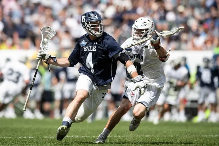 Virginia's Matt Dziama (14) defends against Yale's John Daniggelis (4) in the NCAA Men's D1 Lacrosse Championship Final at Lincoln Financial Field on Monday. Virginia won, 13-9, to capture it's sixth National Championship.