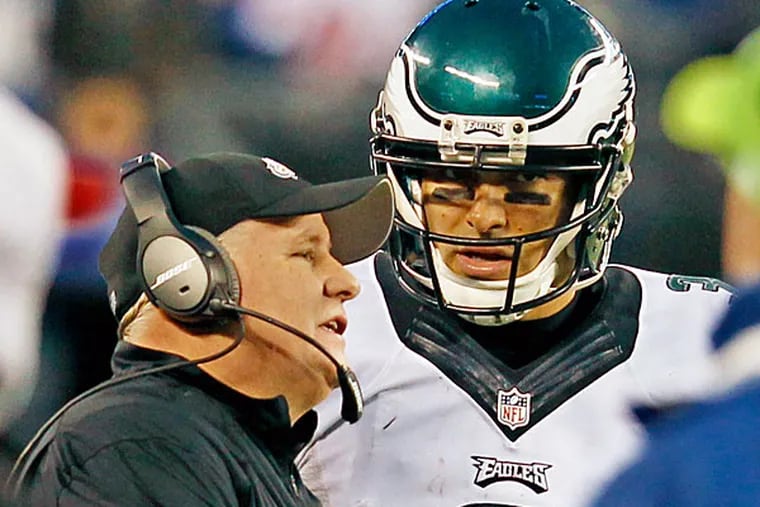 Chip Kelly talks to QB Mark Sanchez during a timeout. (Ron Cotres/Staff Photographer )