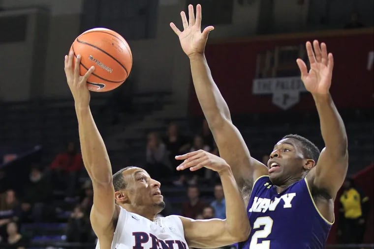 Darnell Foreman, left, of Penn goes up for a shot against Hasan Abdullah of Navy during 1st half at the Palestra at the University of Pennsylvania on Nov. 15, 2017. CHARLES FOX / Staff Photographer