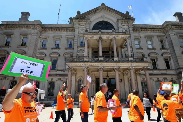 A large group gathers in front of the New Jersey Statehouse on June 30, 2016, in Trenton over New Jersey's Transportation Trust Fund.