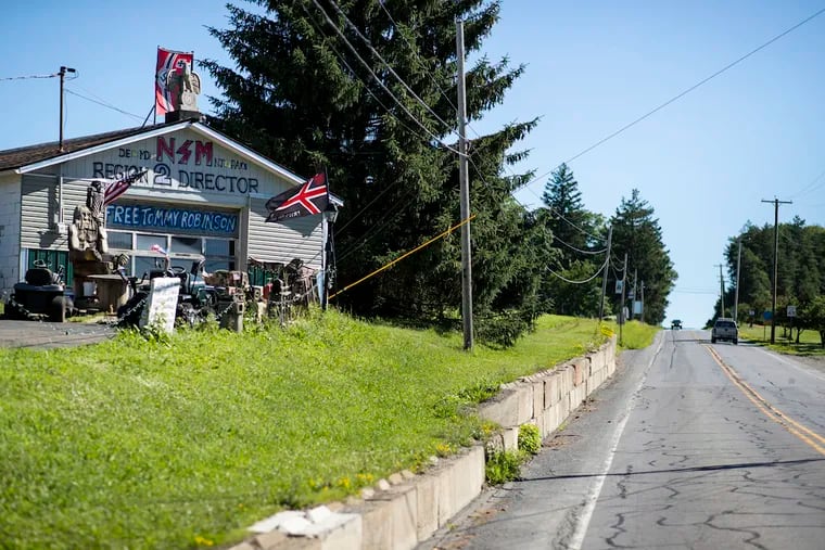 The home of Daniel Burnside in Ulysses, Pennsylvania, displays Nazi and other white-supremacist symbology. NSM stands for the National Socialist Movement. The slogan "Free Tommy Robinson" refers to a British far-right figure jailed by a British judge in May for contempt of court.
