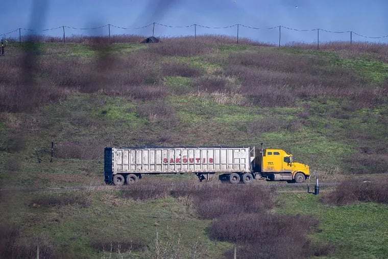 A truck carries trash into the Tullytown Landfill along the Delaware River in Bucks County. Waste Management plans to spruce up the side seen - and smelled - by residents in Florence, N.J.
