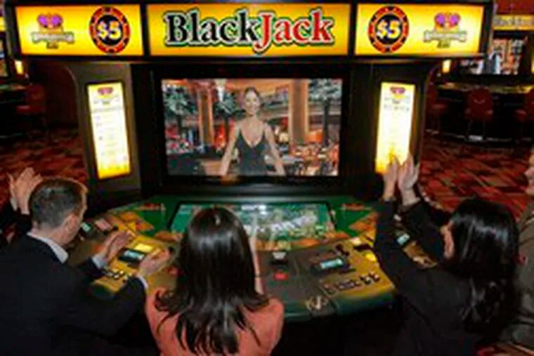 At PhiladelphiaPark Casino in Bensalem, (from left) Kelly Gerrity, Andy Green, Meghan White, Darlene Monzo and Lowell Jacobsen demonstrate one of the new blackjack machines.