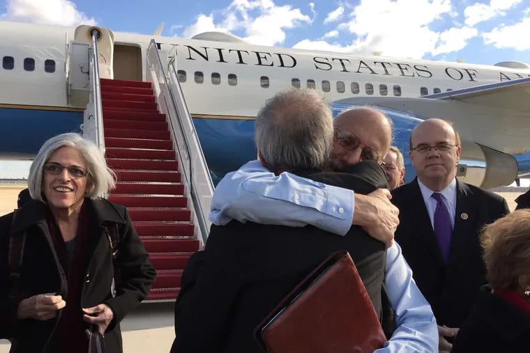 Alan Gross (facing the camera) embraces a Senate aide at Andrews Air Force Base, Md., after his release from Cuba after five years. Gross' wife, Judy, stands at left, and Rep. Jim McGovern (D., Mass.) is at right. Gross' release came after negotiations aided by Pope Francis that led to a restructuring of U.S. policy.