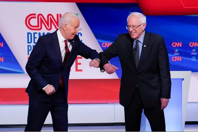 In this March 2020 file photo, then-Democratic presidential candidate Joe Biden (left) and Sen. Bernie Sanders (I., Vt.) greet one another before they participate in a Democratic presidential primary debate at CNN Studios in Washington.