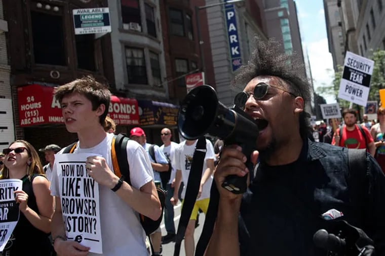 Larry West, one of the leaders of Restore the Fourth's rally against the NSA's surveillance practices, yells into a megaphone during a protest in Philadelphia on the Fourth of July. (Andrew Renneisen / Staff Photographer)