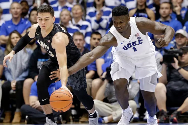 Army's Tommy Funk, left, and Duke's Zion Williamson chasing the ball during a game in 2018.