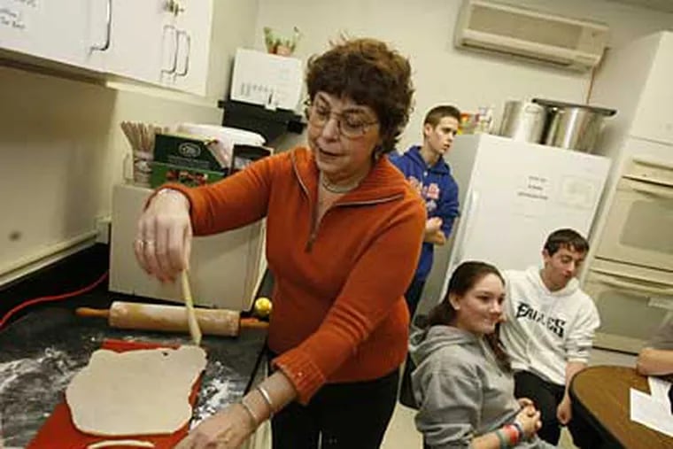 Aliza Green teaches a class of Jewish teenagers to make teiglach, a dessert taken by Jewish traders from Italy to Eastern Europe. The name, in Yiddish, means "little bits of dough." (CHARLES FOX / Staff Photographer)