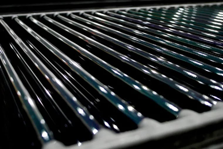 Cylindrical shaped solar cell modules wait to be framed at the
Solyndra Inc. manufacturing facility in Fremont, California. (Ken James/Bloomberg)