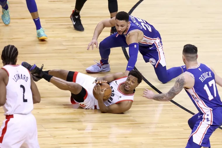 Kyle Lowry tries to call for a timeout while fighting for a loose ball during the Sixers' Game 1 loss to the Raptors.