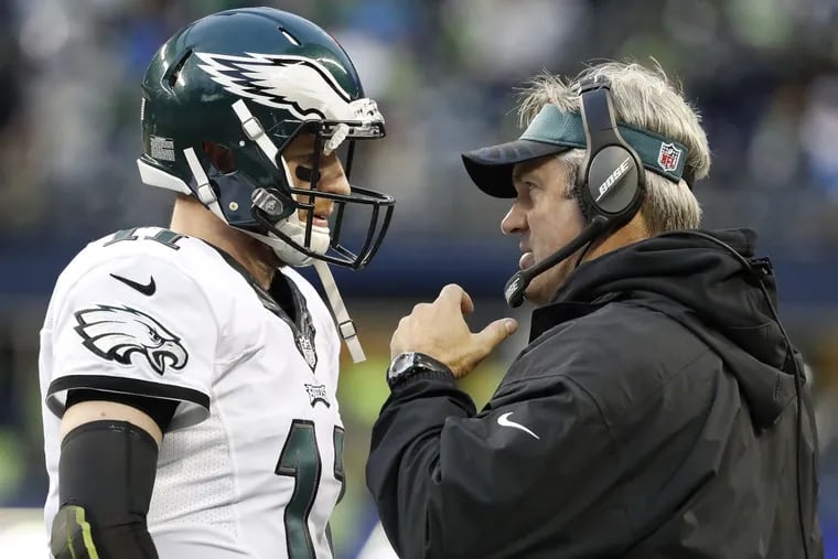 Eagles coach Doug Pederson (right) is hoping quarterback Carson Wentz and the rest of the team don't 'start tanking it in the last month of the season.'