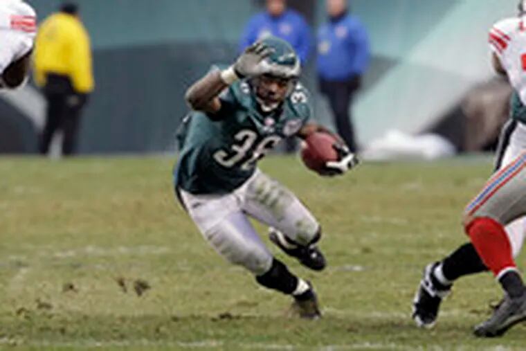 Eagles running back Brian Westbrook heads for daylight, while the Giants&#0039; Justin Tuck (left) and Osi Umenyiora head for him. Westbrook compiled 116 yards and had the Birds&#0039; only touchdown.