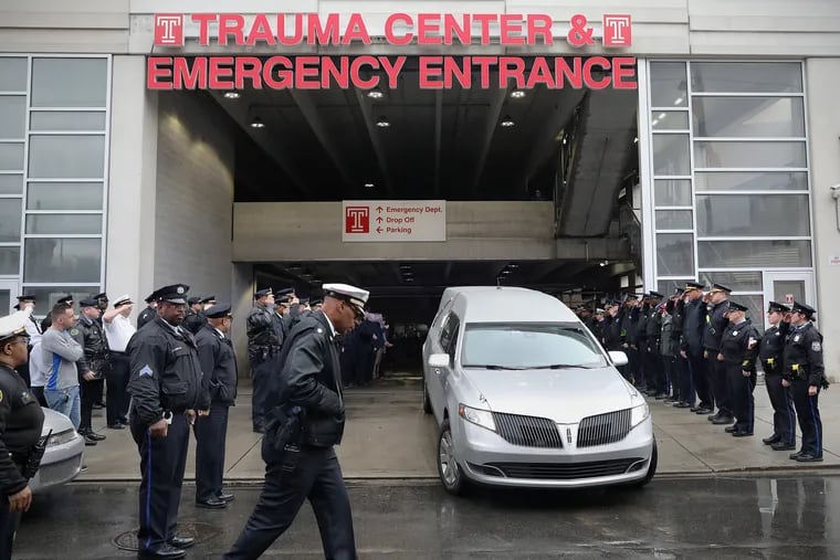 A hearse carries out the body of Philadelphia Police SWAT Cpl. James O’Connor IV from the emergency room entrance at Temple University Hospital in North Philadelphia on Friday. O'Connor was fatally shot early Friday while serving a warrant, according to Commissioner Danielle Outlaw. He was the first officer killed in the line of duty in Philadelphia in five years.