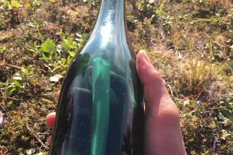 This undated photo provided by Tyler Ivanoff shows a bottle with a message that he found on the shores of western Alaska.