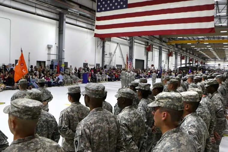 In this Wednesday, Feb. 27, 2013, file photo, members of the 449th Aviation Support Battalion of the Army National Guard participate in a mobilization ceremony at the Army Aviation Support Facility in Austin, Texas in advance of the unit's deployment to Kuwait. (AP Photo/San Antonio Express-News, Bob Owen)