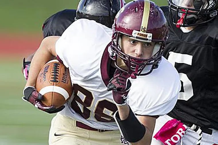 Haverford's Michael Solomon carries in the second quarter. (Ed Hille/Staff Photographer)