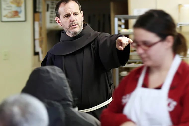 Franciscan monk Brother Fred Dilger points to open seats while meals were served to the Kensington poor at the St. Francis Inn on Thursday, March 6, 2014.  ( Yong Kim / Staff Photographer )