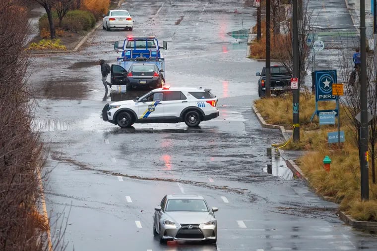 Philadelphia police shut off  Delaware Avenue near Race Street in Center City as a result of flooding in December. More of the same is possible Sunday.
