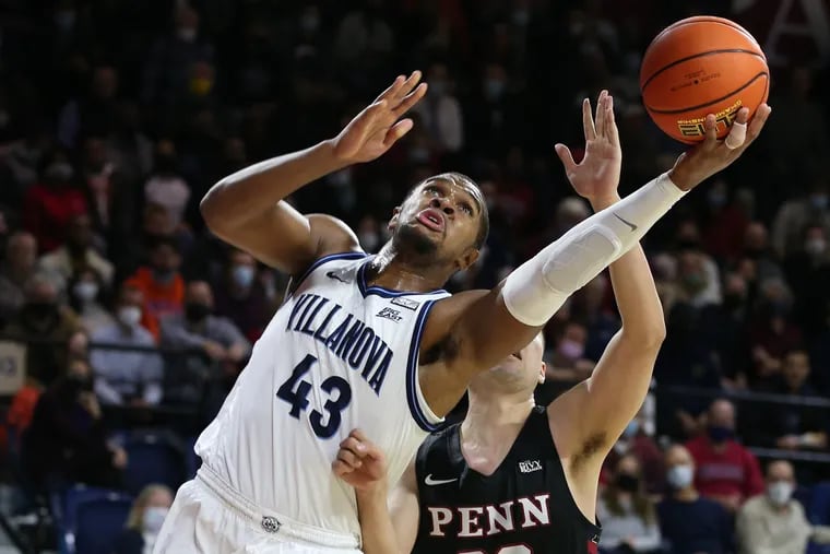 Eric Dixon, left, of Villanova shoots in front Michael Wang of Penn during the 1st half on Dec. 1, 2021 at the Palestra.