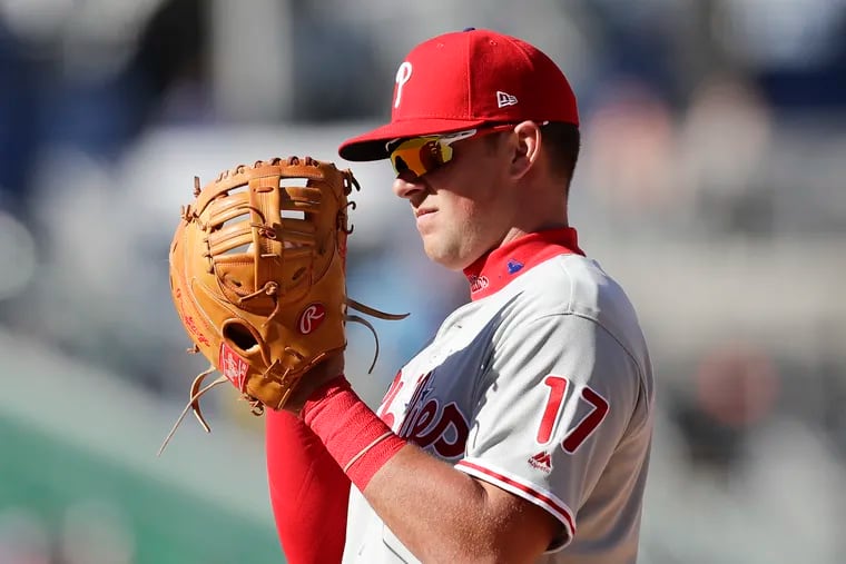Phillies first baseman Rhys Hoskins looks at his glove after committing a catching error that resulted in a run for the Washington Nationals during the eighth-inning on Wednesday, April 3, 2019 in Washington D.C.