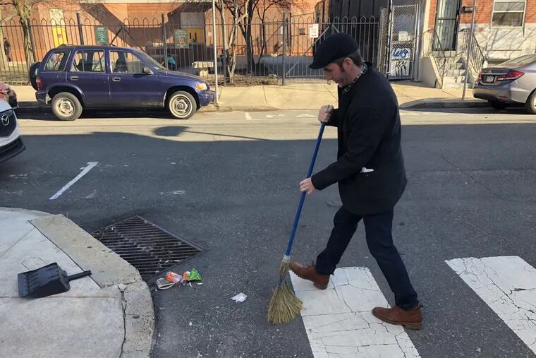 A litterer’s weekly act of penance: Mike Newall sweeps the gutters outside his South Philly home, forever sorry for the sin of once throwing dog poop in the sewer.