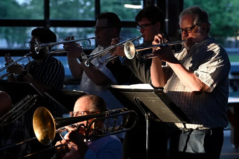 Dave Cianci (left) plays bass trombone and Tony DeSantis (right) is on trumpet during a free big band concert by No Name Pops on the Cherry Street Pier. The ensemble is made up of former Philly Pops musicians.