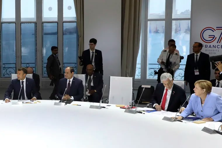 From the left, French President Emmanuel Macron, Egyptian President and Chairman of the African Union Abdel Fattah al-Sissi, Chile's President Sebastian Pinera and German Chancellor Angela Merkel attend a work session focused on climate in Biarritz, southwestern France, Monday Aug. 26, 2019, on the third day of the annual G7 Summit. The empty seat at third right was the place reserved for President Donald Trump, who according to Macron had skipped Monday's working session on the climate. At the same time Macron said that Trump supported an initiative by G-7 countries for an immediate $20 million fund to help Amazon countries fight wildfires and launch a long-term global initiative to protect the rainforest.