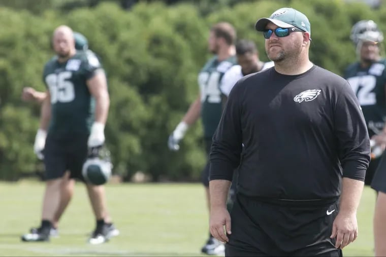 Joe Douglas, front right, at Eagles practice in August 2016.