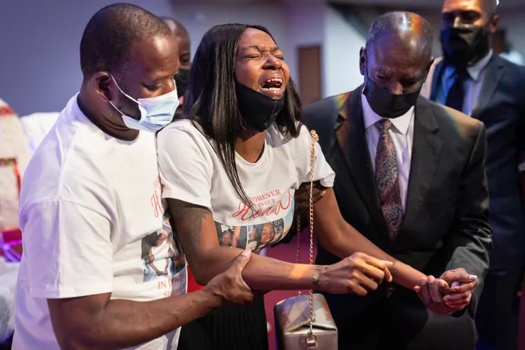 Lendale Rogers (center), Simone's mother, cries out in grief after kissing her daughter goodbye during the viewing at The Church of Christian Compassion, as Simone's father stands by for support on the left.
