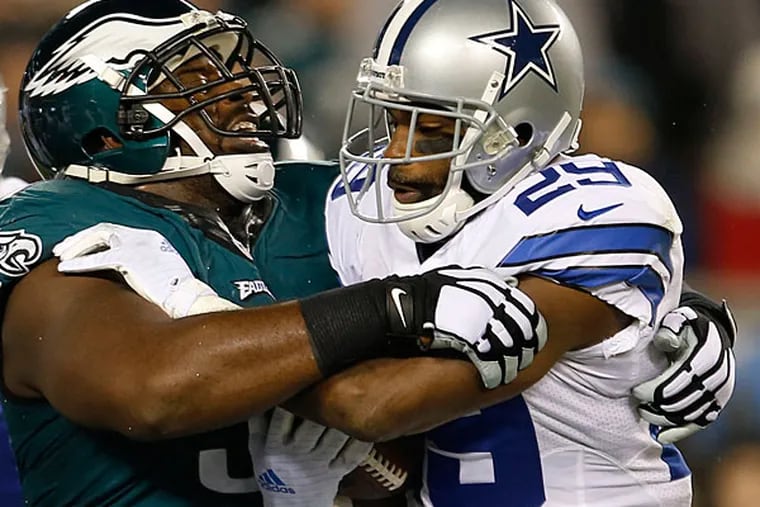 Eagles' Fletcher Cox stops Dallas Cowboys' DeMarco Murray in the
first-quarter on Sunday, December 14, 2014.  (Yong Kim/Staff
Photographer)