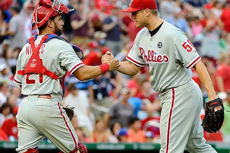 Philadelphia Phillies relief pitcher Jonathan Papelbon (58) is congratulated by catcher Wil Nieves (21) after earning a save against the Washington Nationals at Nationals Park. (Brad Mills/USA Today)