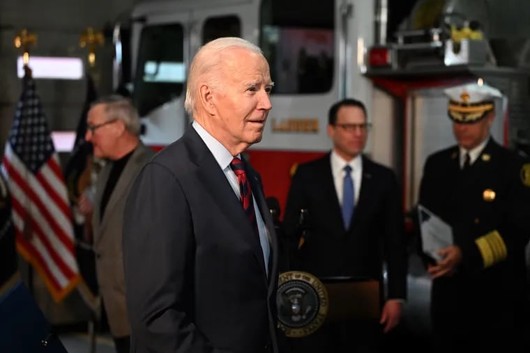 President Joe Biden leaves Ladder 1 on Monday, Dec. 11, 2023, after his announcement of the federal funding that will recommission the fire station closed 15 years ago and several fire companies in the city. Behind him are Mayor Jim Kenney (from left), Pennsylvania Gov. Josh Shapiro, and Philadelphia Fire Commissioner Adam Thiel.
