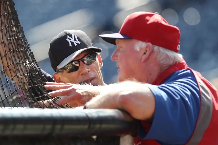 New York Yankees manager Joe Girardi (left)  shares some time at the batting cage with Charlie Manuel during batting practice in 2017.