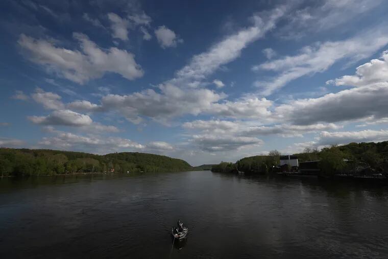 Fishermen wait in their boat near the New Hope Lambertville bridge in the Delaware River as they try their luck on April 30, 2019.