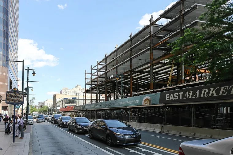 At 11th and Market Streets, a banner along a construction site touts the East Market retail and residential project, which will stretch to Chestnut Street.