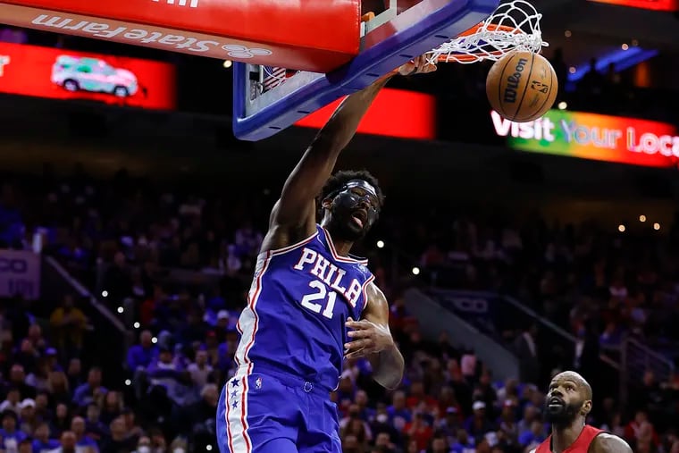 Sixers center Joel Embiid dunks the basketball past Miami Heat center Dewayne Dedmon during the first quarter in game three of the second-round Eastern Conference playoffs on Friday, May 6, 2022 in Philadelphia.