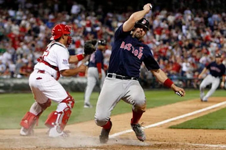 Jason Varitek easily scores Boston's third run in the 13th inning, their fifth of the game, after a hit by Mike Lowell. The Red Sox defeated the Phillies, 5-2, Friday. (Ron Cortes / Staff Photographer)