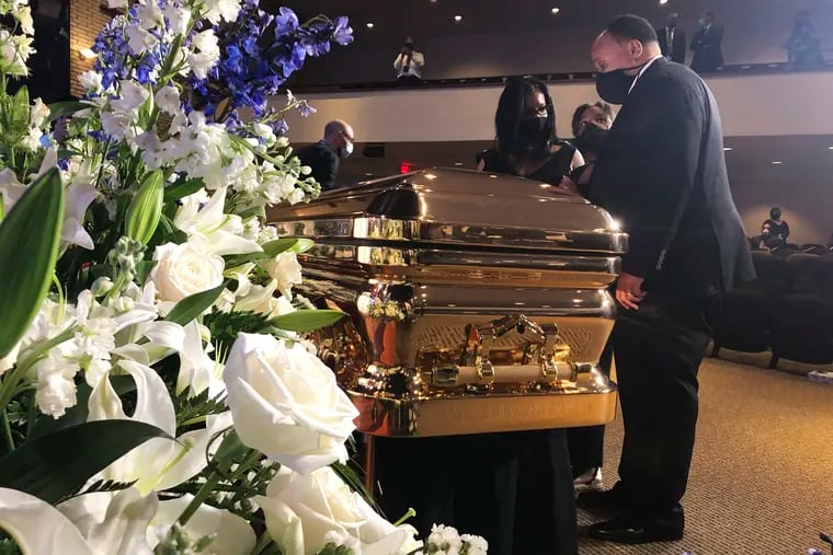 Martin Luther King III takes a moment by George Floyd's casket Thursday, June 4, 2020, before a memorial service for George Floyd in Minneapolis.