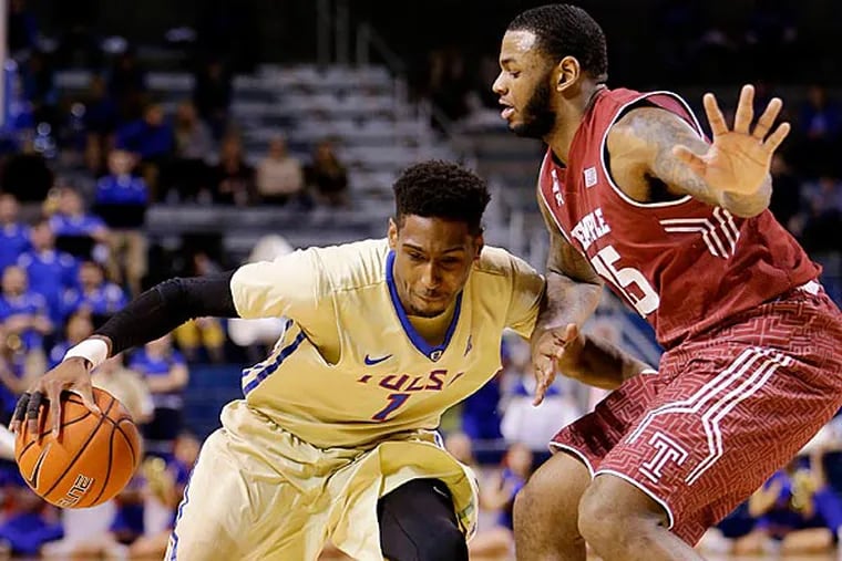 Tulsa's Rashad Smith drives the ball against Temple's Jaylen Bond during the NCAA basketball game in Tulsa, Okla., Sunday, Feb. 17, 2015. (Mike SImons/AP, Tulsa World)