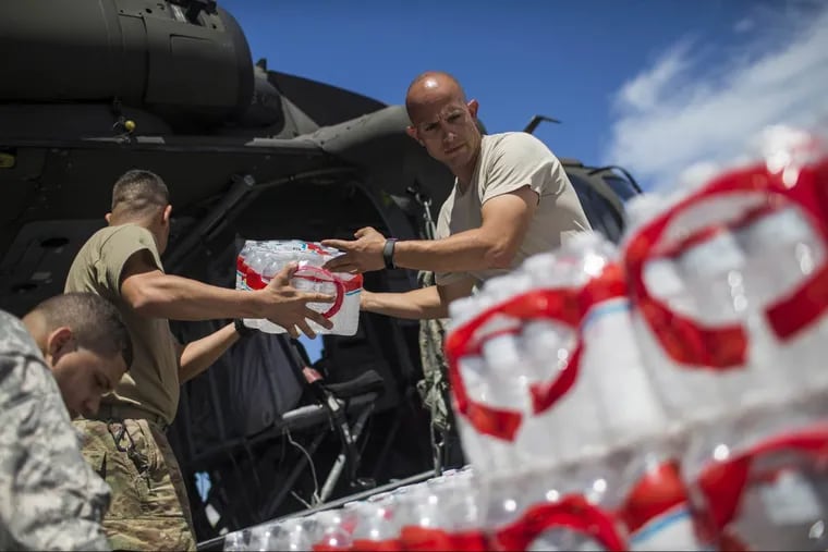 Army and National Guard troops load water and food into helicopters for delivery across Puerto Rico. Officials estimated about half the territory’s residents didn’t have access to clean water.