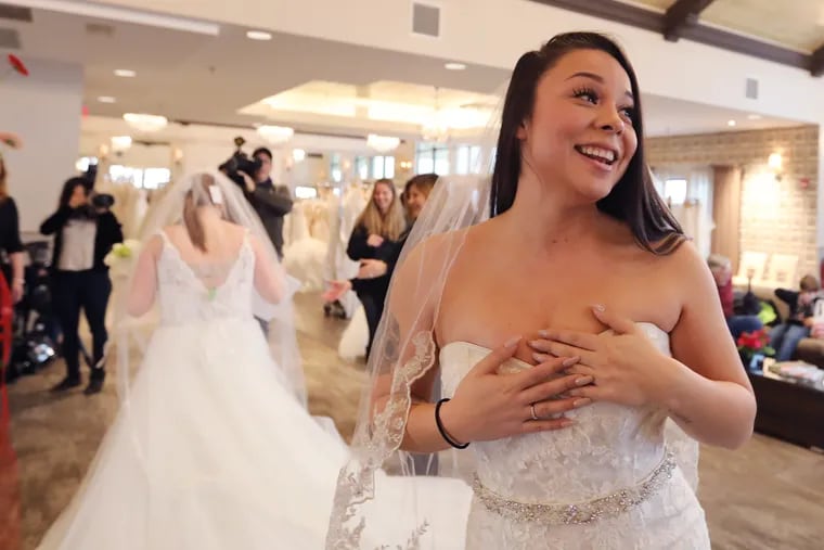 Priscilla Pazmino, 29, Air Force (ret.), Pemberton, finds the perfect dress. Brides-to-be from South Jersey who are veterans or family members get a chance to select wedding gowns at a special free offering sponsored by Camden County. About 500 dresses were turned over to the county by M&M Realty Partners, LLC after the unexpected closure of Alfred Angelo Bridal at Garden State Park in Cherry Hill.