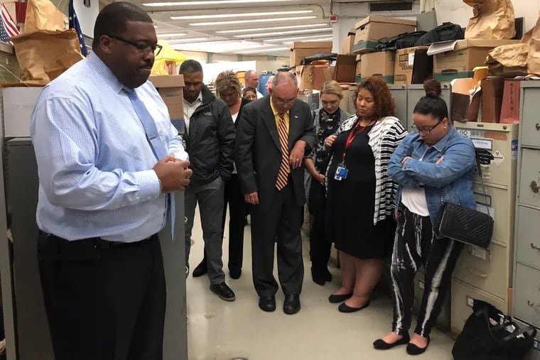 Philadelphia Police Lt. Norman Davenport leads loved ones of homicide victims in prayer at a recent breakfast for detectives at the offices of the homicide unit.