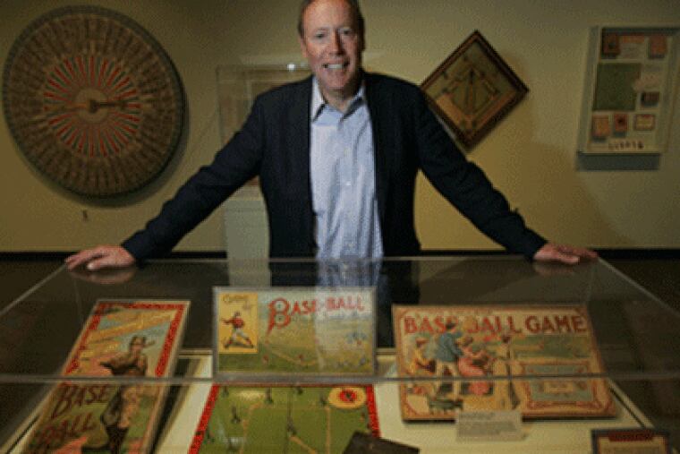 Mark Cooper shows off his collection of baseball board games at the National Baseball Hall of Fame in Cooperstown, NY. (Laurence Kesterson / Inquirer)