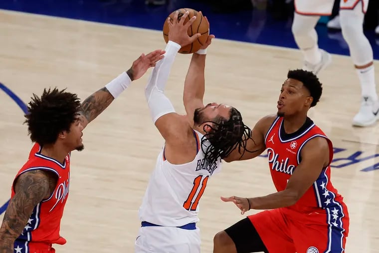New York Knicks guard Jalen Brunson gets fouled by Sixers guard Kelly Oubre Jr., with teammate guard Kyle Lowry in game one of the first round of the NBA Eastern Conference playoffs on April 20.