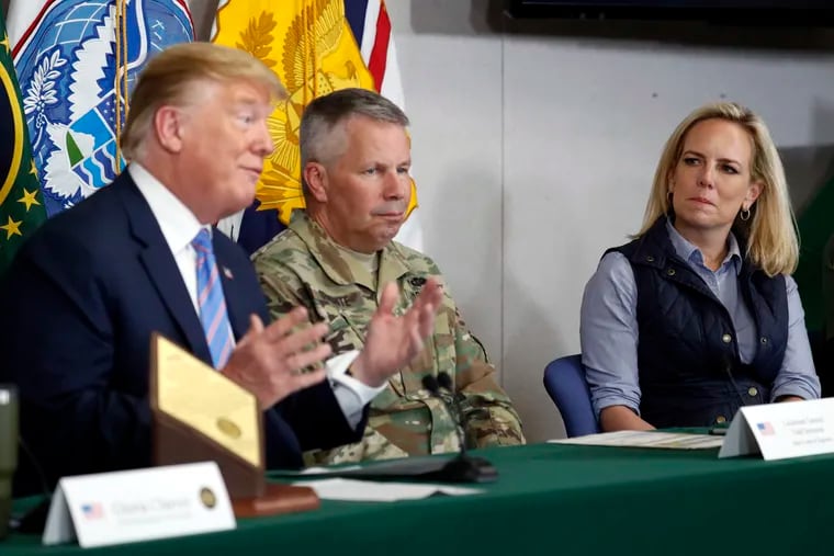 Lt. Gen. Todd Semonite, commanding General of the U.S. Army corps of Engineers , center and Homeland Security Secretary Kirstjen Nielsen, listens as President Donald Trump participates in a roundtable on immigration and border security at the U.S. Border Patrol Calexico Station in Calexico, Calif., Friday April 5, 2019. Trump headed to the border with Mexico to make a renewed push for border security as a central campaign issue for his 2020 re-election.
