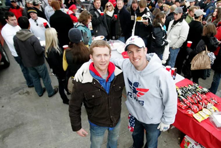 Sam Linn and Mike Erwin tailgate before the Army-Navy game. (David
Swanson / Staff Photographer)