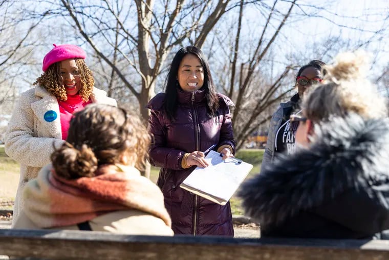 Mayoral candidate Helen Gym (center) and City Councilmembers Jamie Gauthier (left) and Kendra Brooks (right) walk around Clark Park on Saturday seeking signatures for  petitions to be on the Philadelphia ballot.